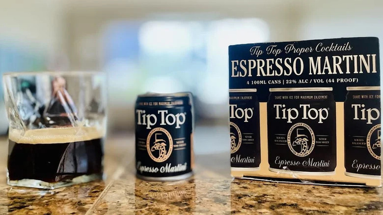 Tip Top Espresso Martini poured into a glass next to a box of them