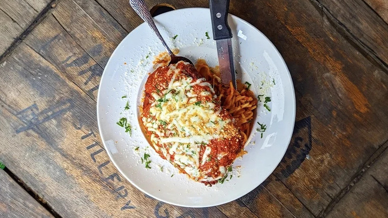 A plate of Gaetano's parm on a wooden table