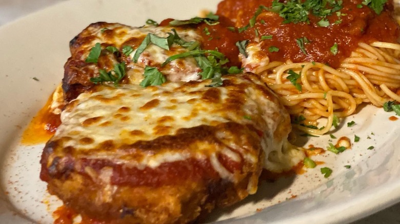Chicken parm from Bella Napoli sprinkled with fresh herbs