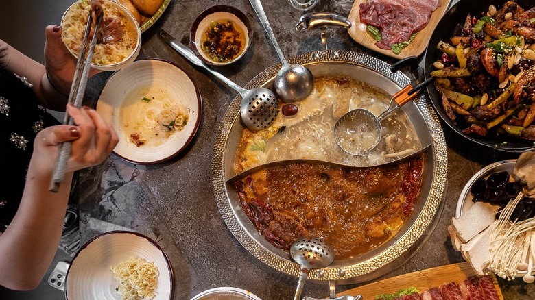 People enjoying a Sichuan hot pot at Szechuan Mansion Hotpot in North Carolina