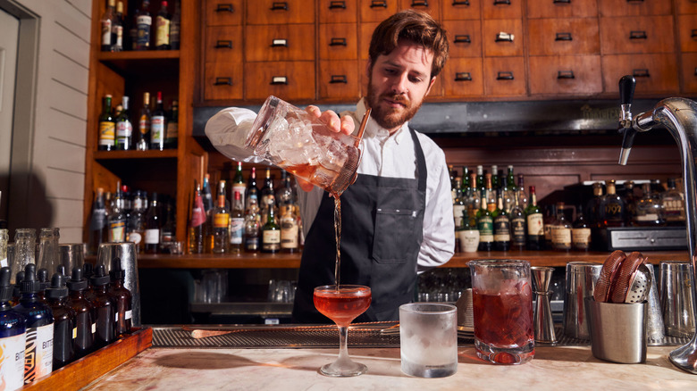 Bartender pours a cocktail at The Apothecary in Jackson