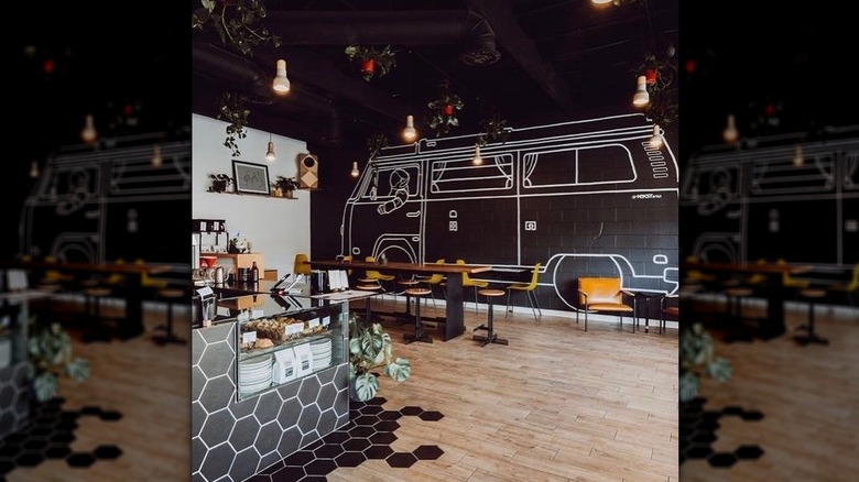 Interior of Slow by Slow coffee bar, with tables and corner of counter