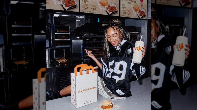Woman enjoying Don Julio and Popeyes collaboration meal sitting on counter.