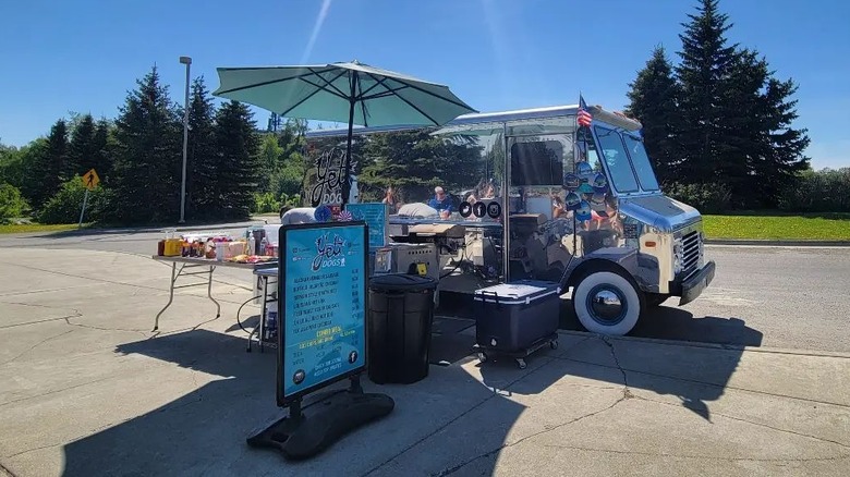 Yeti Dogs truck with condiment table and signage in a rural parking lot