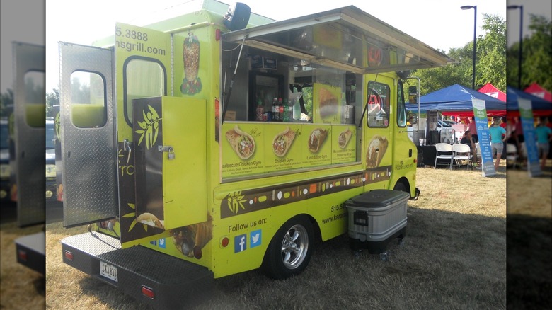 The yellow food truck of Karam's Mediterranean Grill open for business