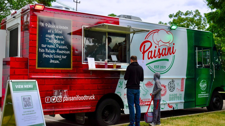 Two people standing at Paisani Food Truck