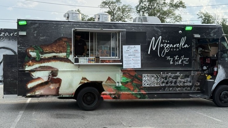 Exterior of The Mozzarella God food truck in a parking lot