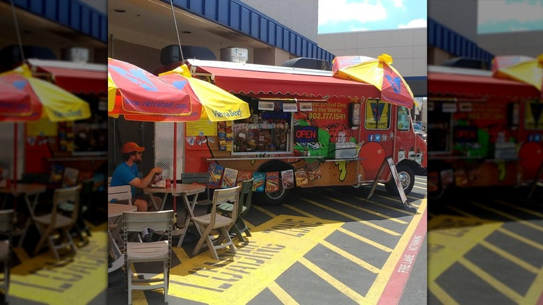T.J.'s Dawg House parked with patio tables outside