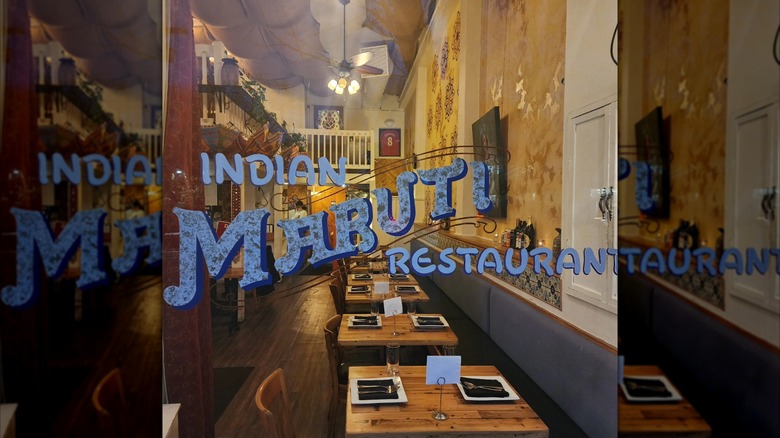 Image peering into Maruti through the glass front door