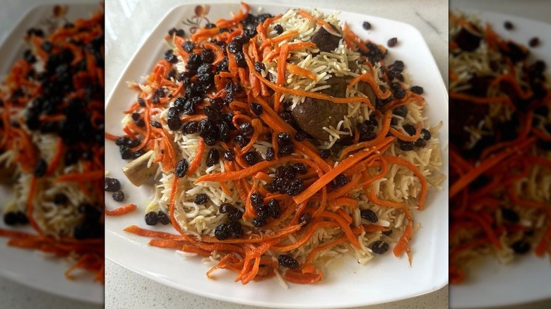 Kabuli Pulao rice dish with lamb, carrots, and raisins on a white plate at Taste of Persia