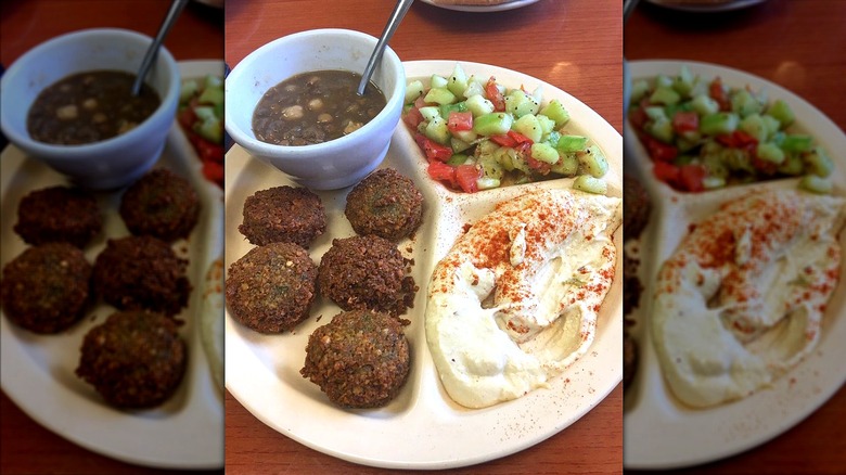 Paper plate of falafel, hummus, and mixed vegetable salad at Oasis Falafel