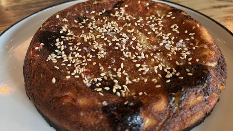 Close up of the black sea cornbread on a white plate at Sarma restaurant