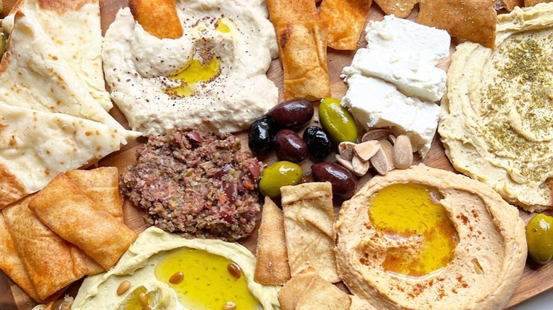 Assorted dips, feta, nuts, olives, and pita bread at Holy Land