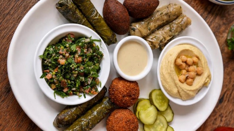 Appetizer platter with stuffed grape leaves, tahini sauce, falafel, kibbe, hummus, and tabbouli at Sayde's Bar & Grill