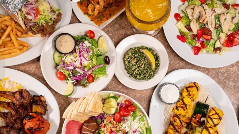 Assorted dishes at Zorba's Mediterranean Cuisine, including greek salad, souvlaki, lamb chops, and gyros