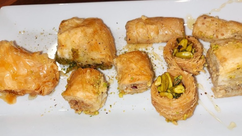 Assorted pastries on a white plate, like baklava, at Azar's Mediterranean Specialties