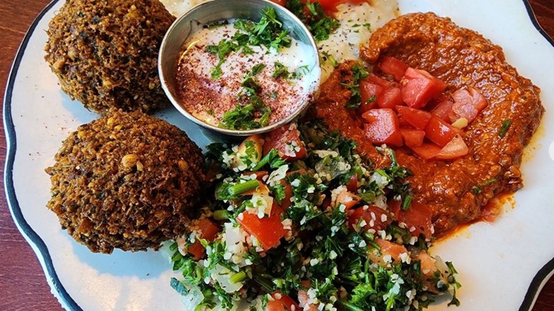 Appetizer platter of falafel, tzatziki sauce, hummus, tabbouli, and vegetable dip at Taza Mediterranean