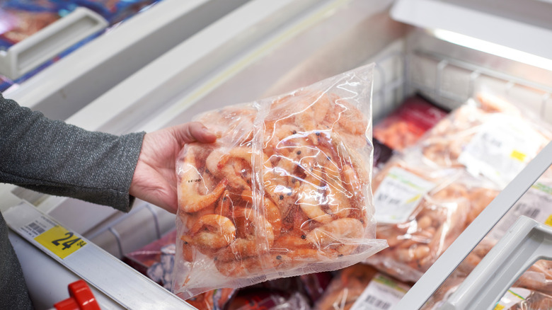 picking up frozen shrimp at the grocery store