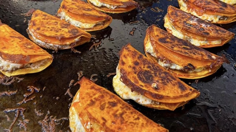 Quesabirria tacos on the grill at El Pique