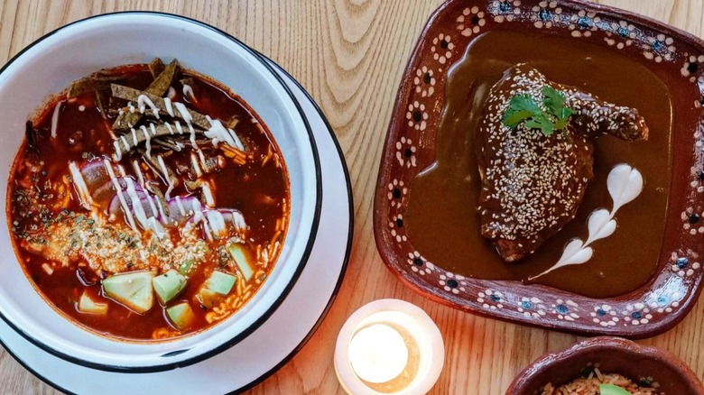 A bowl of pozole and chicken mole at Cielo Rojo