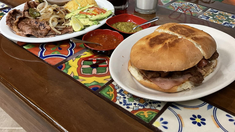A plate of carne asada and a torta at La Morena