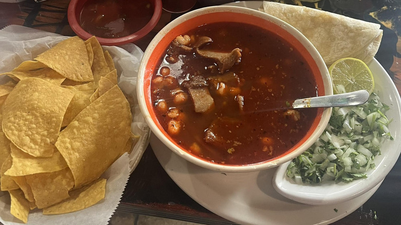 A bowl of menudo with tortilla chips at Vaqueros Taqueria and Mexican Restaurant