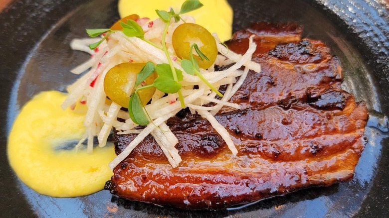 A plate of glazed pork belly with corn puree at Fonda San Miguel