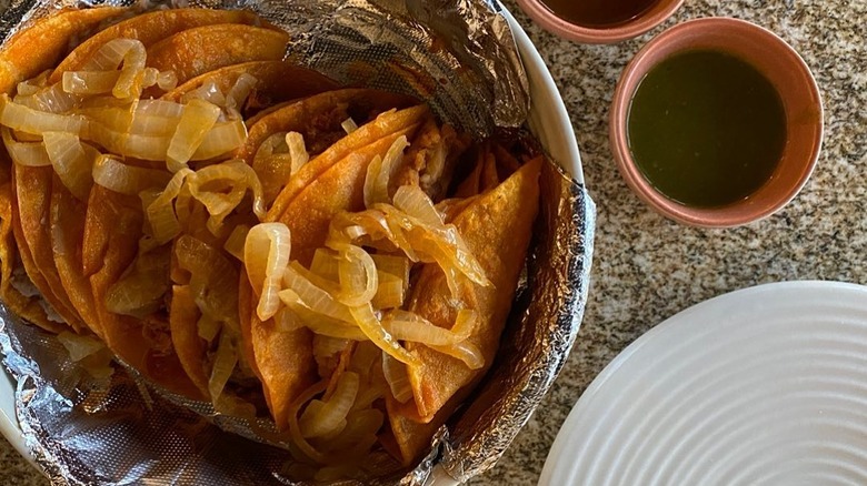 A basket of tacos de canasta at La Casa Del Tamal