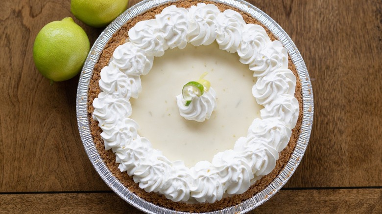 Whole key lime pie garnished with whipped cream
