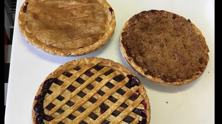Three whole fresh pies on a countertop