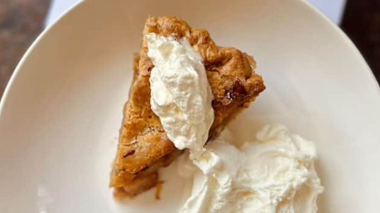 Slice of apple pie with fresh whipped cream