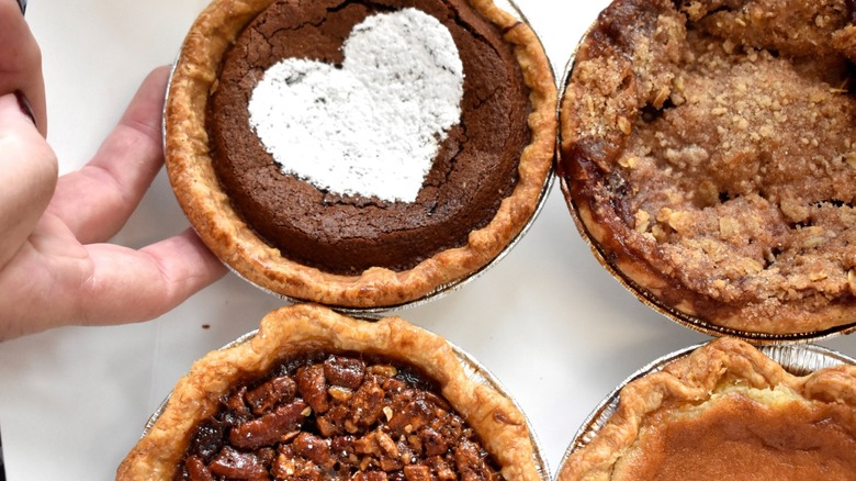 Four mini handheld pies in tins