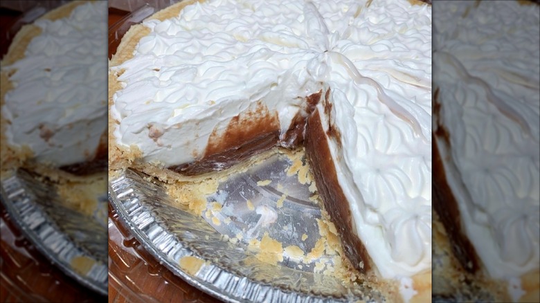 Chocolate haupia cream pie with a slice missing