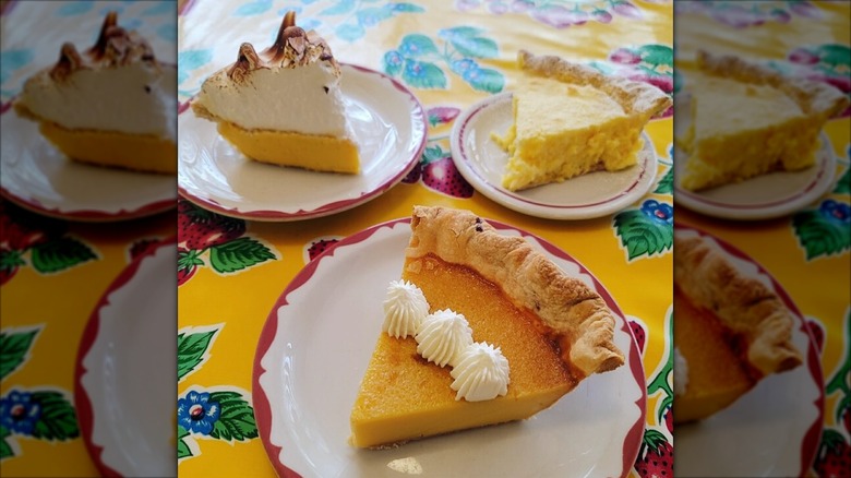 Three slices of pie on decorative white plates with red rims