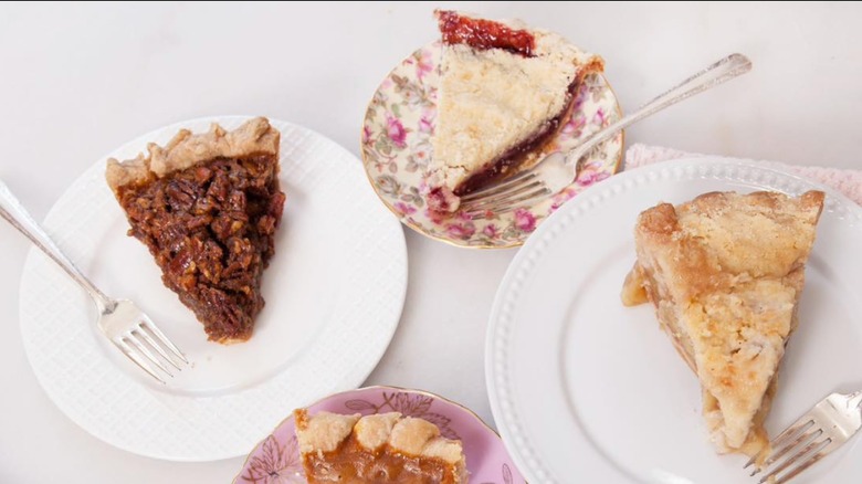 Assorted slices of pie on decorative plates