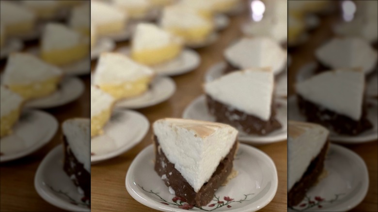 Slices of chocolate and lemon meringue pie on plates