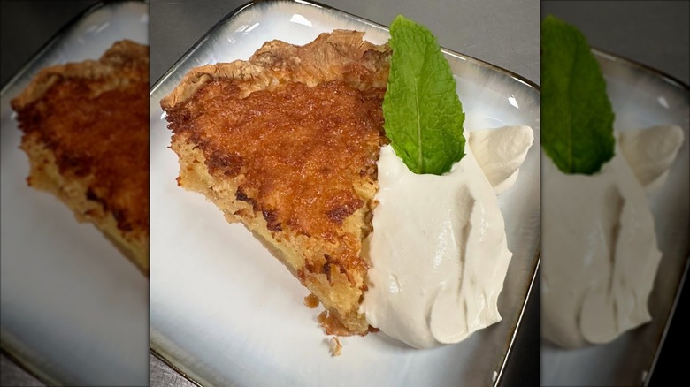 Slice of apple crumb pie with fresh whipped cream