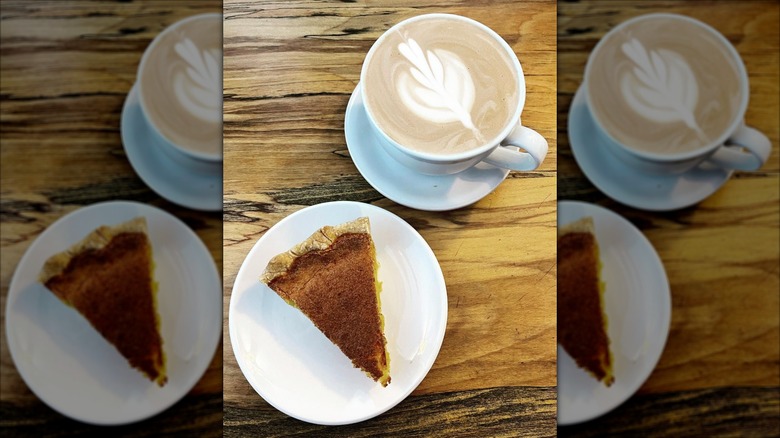 Slice of Chess pie on a plate and a cup of cappucino