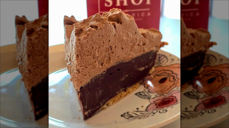 Slice of chocolate mocha cream pie on floral decorative plate