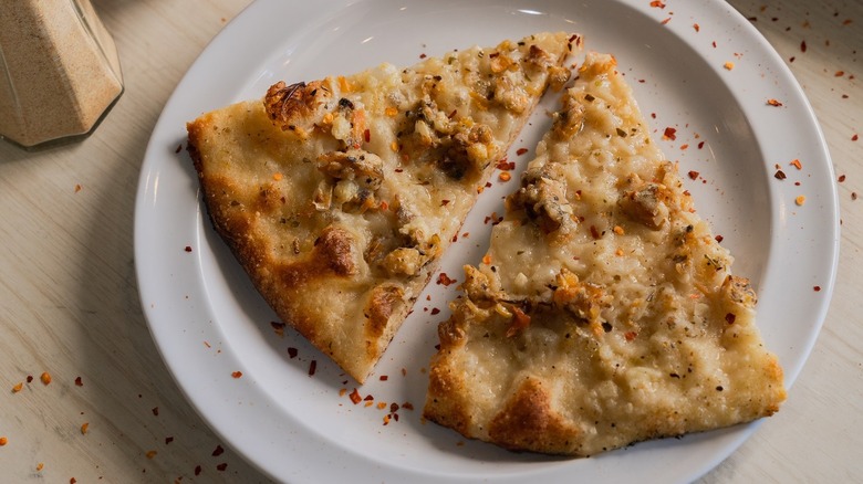 Two pieces of White clam pizza at Frank Pepe Pizzeria Napoletana