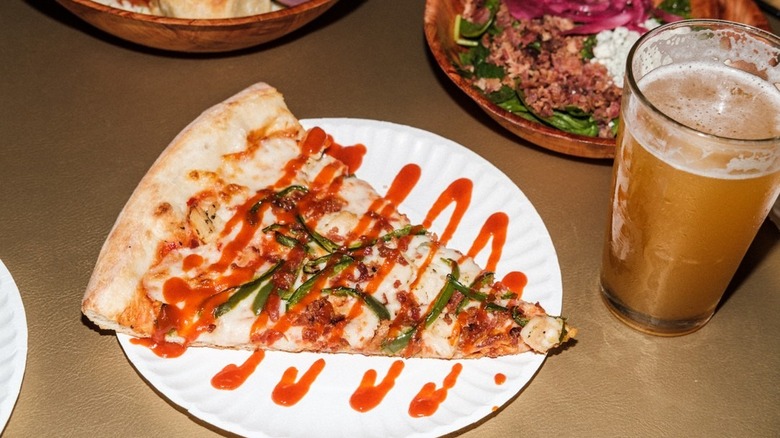 A slice of Foghorn Leghorn pizza at Empire Slice