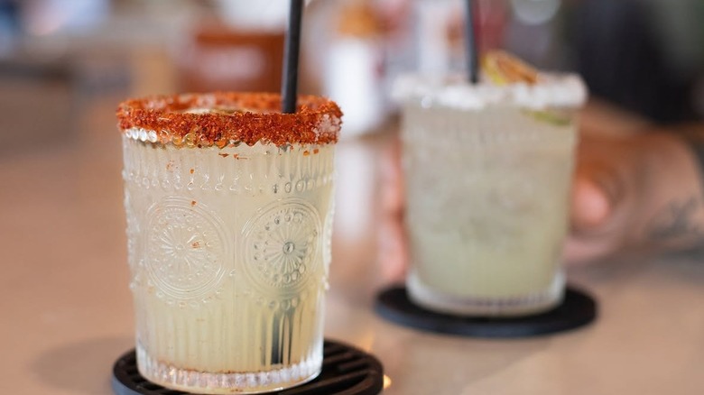 Margarita glasses clink at Coco Deck Kitchen + Bar Lahaina