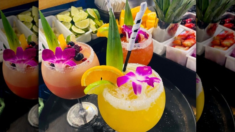 Margaritas garnished with edible flowers and salt rims from El Rincón Restaurant
