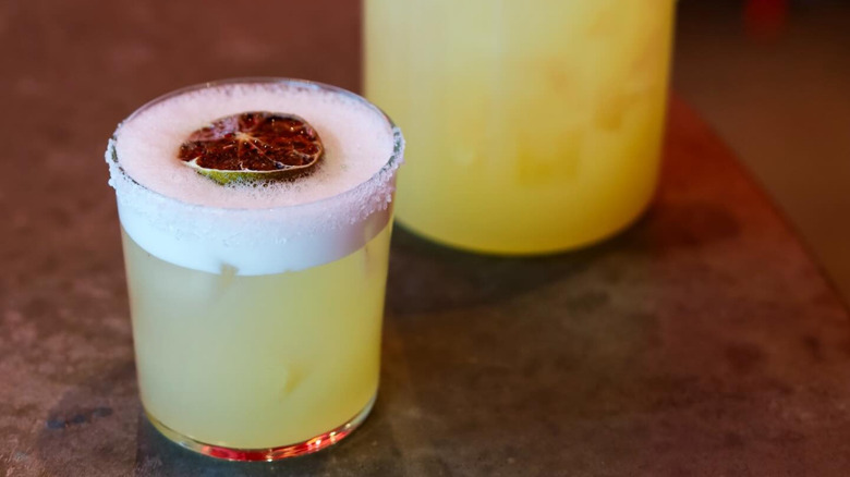 A margarita with a dried lime garnish from Noche Woodfired Grill & Agave Bar