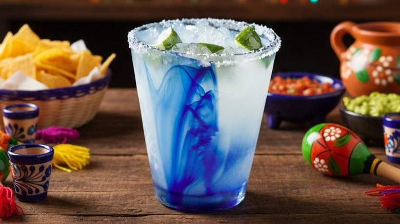 One hand grabs a margarita from Mariano's Hacienda