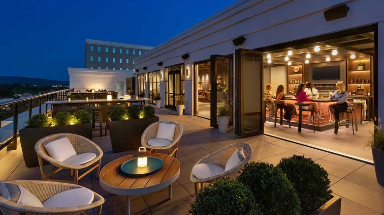 Photo showing the view, outdoor patio, and indoor bar at Baker & Able