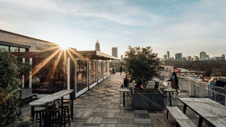 Outdoor seating at 9 Mile Station with views of the skyline