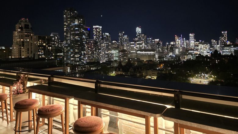 View of a city skyline from a rooftop bar