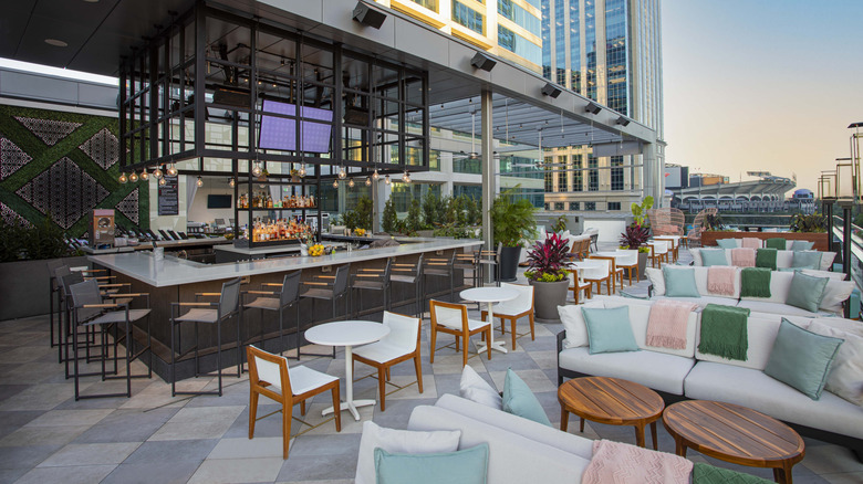 View of the lounge seating and bar area at Aura Rooftop