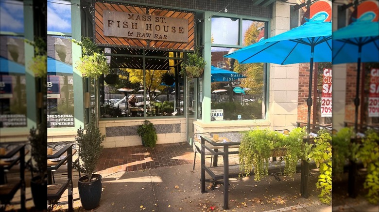 Front exterior of Mass St. Fish House and Raw Bar with patio tables in front